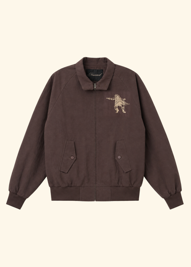 A dark brown corduroy bomber jacket with a beige embroidered lion graphic on the left chest, displayed flat against a light cream background.