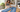 Woman inspecting a small stain on NOEND jeans laid flat on a laundry table