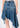 Noend Denim Mandy asymmetrical denim skirt with uneven hem and classic blue wash, styled on a model.