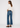 Noend Denim Farrah Mid Rise Kick Flare jeans with bootcut style and light wash denim, hanging on a hanger.