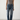 Person wearing a gray tank top and Noend blue regular fit jeans against a white background