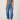 Woman wearing a Noend gray tank top and Noend slung fit
 blue jeans on a white background