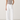 Person wearing a gray tank top and Noend white pants on a plain background