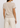 Person wearing a beige t-shirt and pants on a white background