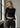 Black ribbed long sleeve crop top by Noend Denim, featuring a fitted design and ribbed texture, shown on a plain background.