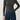 Person wearing a Noend dark green ribbed top and blue jeans on a light gray background